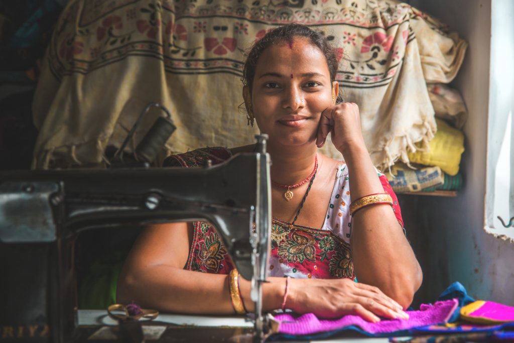 Bhavna Ben Ramesh in front of her sewing machine