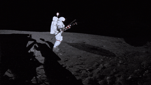 Astronauts Neil Armstrong and Buzz Aldrin unfurl the American flag on the Moon's surface