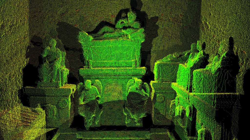Glowing greenish 2-dimensional view of statues of human figures in a 3-dimensional scan of the interior of in the Hypogeum of the Volumnis in Perugia, Italy.