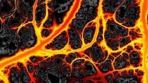 Veins of hot glowing orange lava flowing through vein-like channels in dark black volcanic rock.