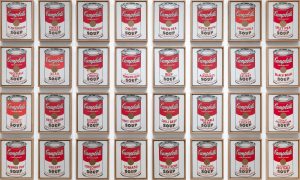 Multiple framed red and white silkscreen paintings of cans of different Campbell’s Soups by Andy Warhol, circa 1962.